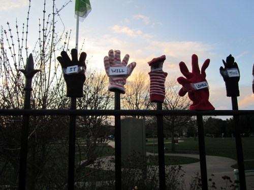 Lonely gloves on park fence - it will be