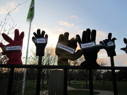 Lonely gloves on park fence - lonely this Christmas without you