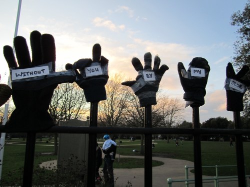 Lonely gloves on park fence - without you by my side