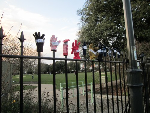 Lonely gloves on park fence